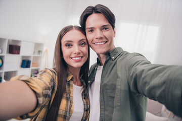 Canvas Print - Photo of charming sweet young couple wear casual outfits smiling embracing recording self video indoors house room