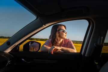 Wall Mural - woman stop to enjoy sunset at road trip