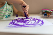 Hand Of Small Child Learning To Drew With Purple Marker