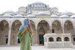 © Ivan - a young woman in a headscarf and dress walks through the territory of the Blue Mosque in Istanbul.