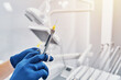 © dimik_777 - a dentist holds a dental syringe in a dental clinic