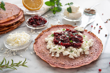 Wall Mural - Close-up of pink pancakes with beetroot and feta, and green pancakes with spinach