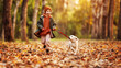 © JenkoAtaman - Happy joyful little boy walking with dog white golden retriever puppy in beautiful autumn forest