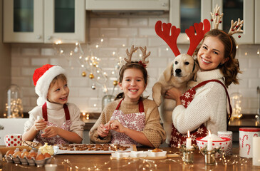 Poster - Happy family mother, two kids with dog golden retriever in kitchen, preparing Christmas cookies