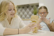 © Olleg1 - two girls have fun playing Jenga together - board game to remove wooden blocks and kids leisure concept