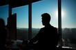 © Liubomir - Successful businessman boss working at computer on the background of large windows, silhouette