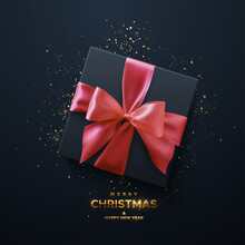 Merry Christmas And Happy New Year Golden Sign. Black Gift Box With Pink Bow And Crossing Ribbons On Black Background.