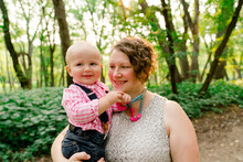 Lifestyle Portrait Of A Mother Holding Her Baby Boy