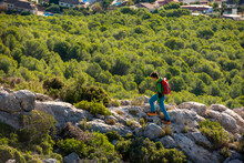 Young Man Treks Through Rocky Landscape At Sunrise, Costa Blanca
