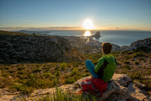Young Man Looking At Dawn Over Rocky Landscape , Calpe, Costa Blanca