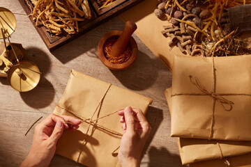 Traditional chinese medicine with herb and spices in brown wooden background mortar and pestile with a pack of medicine , for medicine advertising , photography traditional medicine content