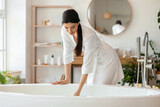Pretty young woman getting ready to take bath at home Stock Photo