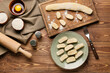 Plate with delicious dumplings on wooden background