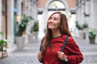 © Farknot Architect - A young asian woman walking on the street while traveling and sightseeing around the city