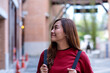 © Farknot Architect - A young asian woman walking on the street while traveling and sightseeing around the city