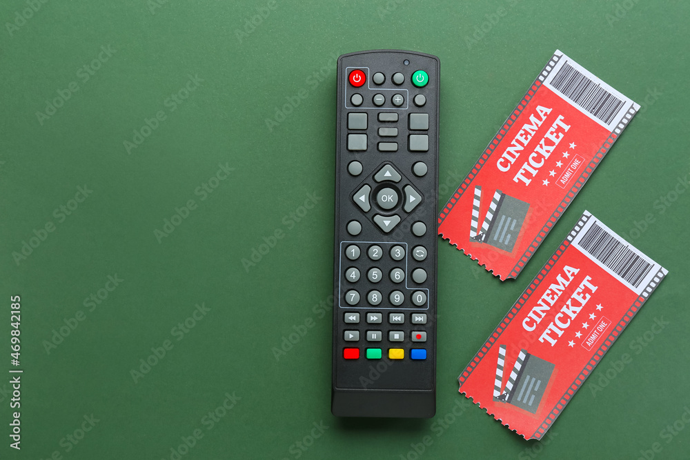 Modern TV remote control and cinema tickets on color background