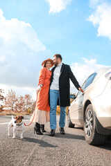 Canvas Print - Lovely couple with Jack Russel terrier near car