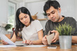 © KMPZZZ - Stressed asian young couple family, wife and husband confused by calculate expense from invoice or bill, have no money to pay. Mortgage, loan causing debt, bankruptcy. Debt problems, Financial people.