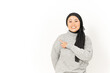 © Sino Images Studio - Pointing aside of Beautiful Asian Woman Wearing Hijab Isolated On White Background