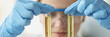 © megaflopp - Woman chemist holds in hands two test tubes with yellow transparent liquid for research