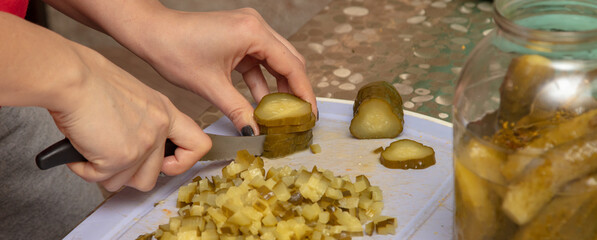 Wall Mural - The chef slices pickles with a knife