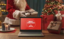 Santa Bringing Gifts And Wishes On A Laptop