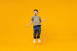 © ViDi Studio - Full body overjoyed excited little small smiling happy boy 6-7 years old wearing green t-shirt jump high isolated on plain yellow background studio portrait Mother's Day love family lifestyle concept