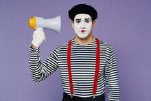 Charismatic Serious Businesslike Frowning Young Mime Man With White Face Mask Wears Striped Shirt Beret Hold Megaphone Directed To Headisolated On Plain Pastel Light Violet Background Studio Portrait.