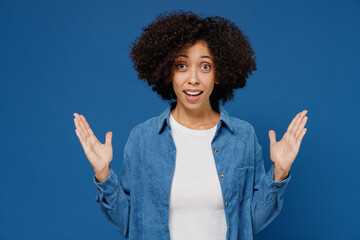 Wall Mural - Young surprised impressed shocked impressed happy black woman in casual clothes shirt white t-shirt spread hands isolated on plain dark blue color background studio portrait. People lifestyle concept.