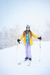 © Mikhail Mishchenko - Portrait of cheerful skier girl in yellow jacket in a snowy weather