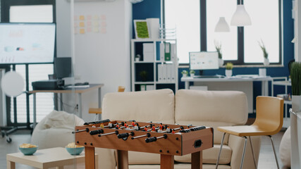 Wall Mural - Nobody in workplace used for meeting with businesspeople after work. Empty office with foosball table to play football game, bottles of beer and snacks, enjoying party celebration