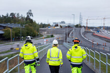 Construction Workers Walking Along Road