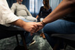 © Johnér - Mid section of people holding hands during therapy