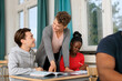 © Johnér - Teacher helping students in classroom