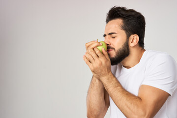 bearded man in white t-shirt apple health proper nutrition