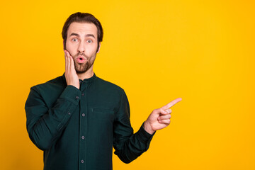 Poster - Photo of funny shocked young man wear smart casual outfit pointing finger empty space arm cheek isolated yellow color background