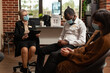 © DC Studio - Woman therapist talking to african american man at support group therapy, sitting in circle. People at aa meeting discussing alcohol addiction and mental health problems, wearing face masks.