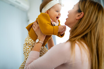 Wall Mural - Mother and baby playing and smiling. Happy family.