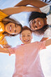 © kegfire - Happy diverse kids hugging against sky