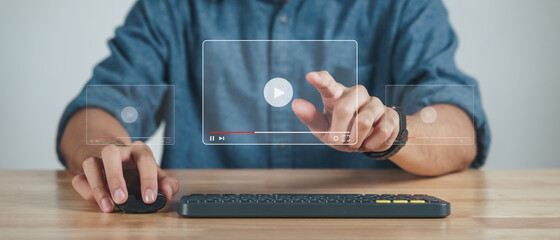 Man using computer mouse and keyboard for watching video on the internet, online streaming, online class, content creator.