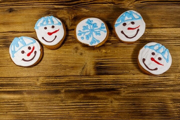 Wall Mural - Christmas gingerbread cookies on a wooden background. Top view, copy space