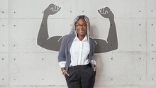  Business Woman Lean On Wall With Copyspace At Right Side And Shows Biceps