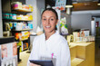 © 2Design - Young female expert pharmacist is making notes while standing