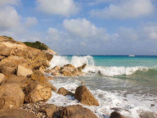 Rocky sandy beach, coastline with turquoise sea, wave splash, Catalonia, Spain