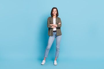 Wall Mural - Full body photo of cool satisfied glad lady stand with folded arms wear khaki clothes isolated over sky light color background