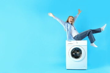 Wall Mural - Concept of housework with washing machine and girl on blue background