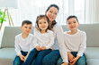© Louis-Paul Photo - Loving mother with kids enjoying time together at home sofa