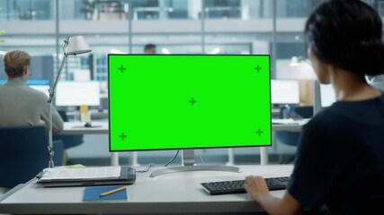Poster - Close Up Over the Shoulder Shot of a Businesswoman Working on Desktop Computer with Chroma Key Green Screen Mock Up Display. Digital Projects Manager Typing Data, Using Keyboard and Mouse.