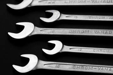 Wall Mural - Steel wrenches from chrome vanadium steel on black background closeup. Selective focus