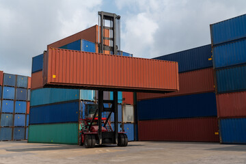 Cargo container for overseas shipping in shipyard with heavy machine . Logistics supply chain management and international goods export concept .